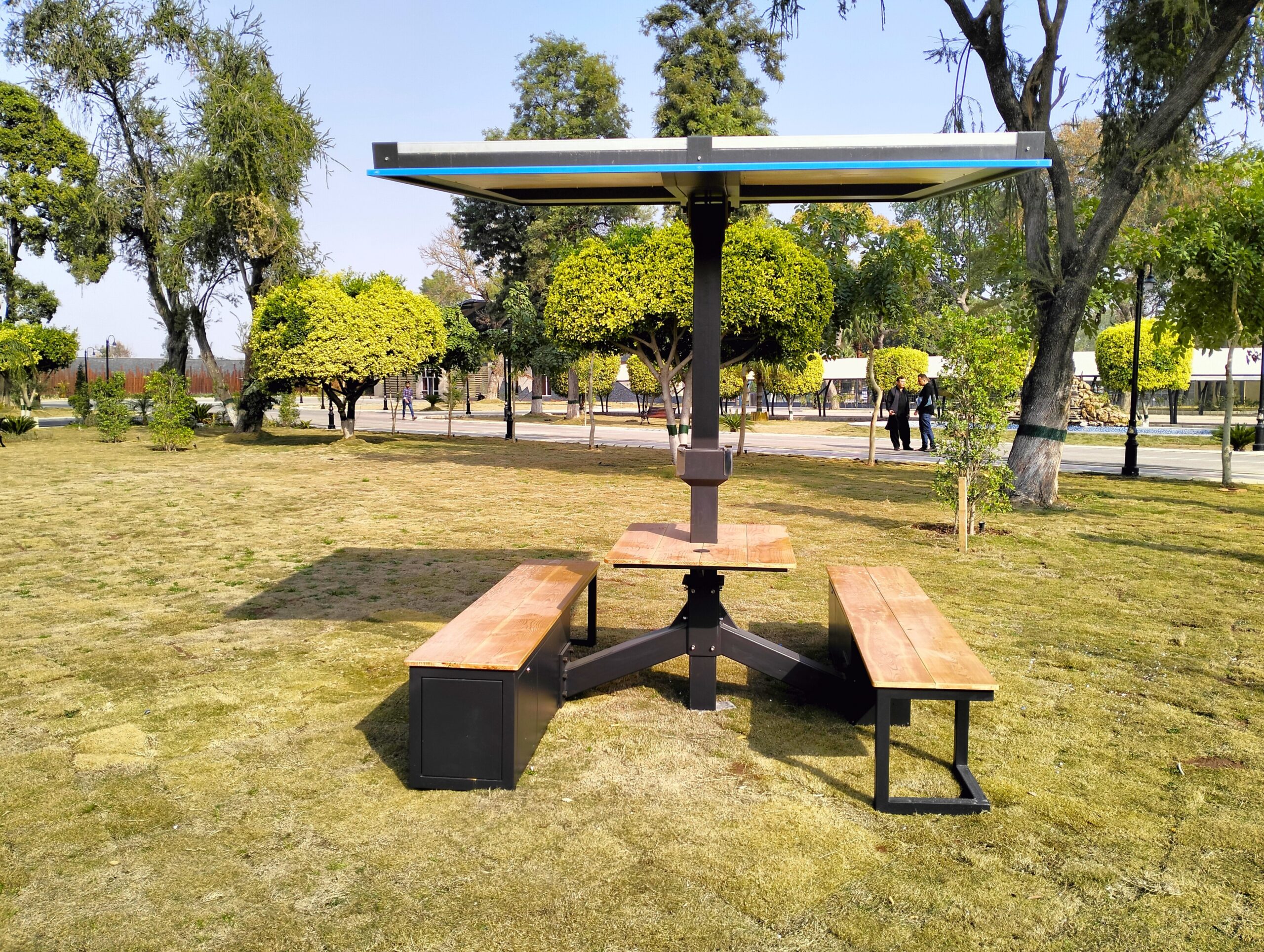 a beautiful solar umbrella installed for gadgets charging and outdoor sitting