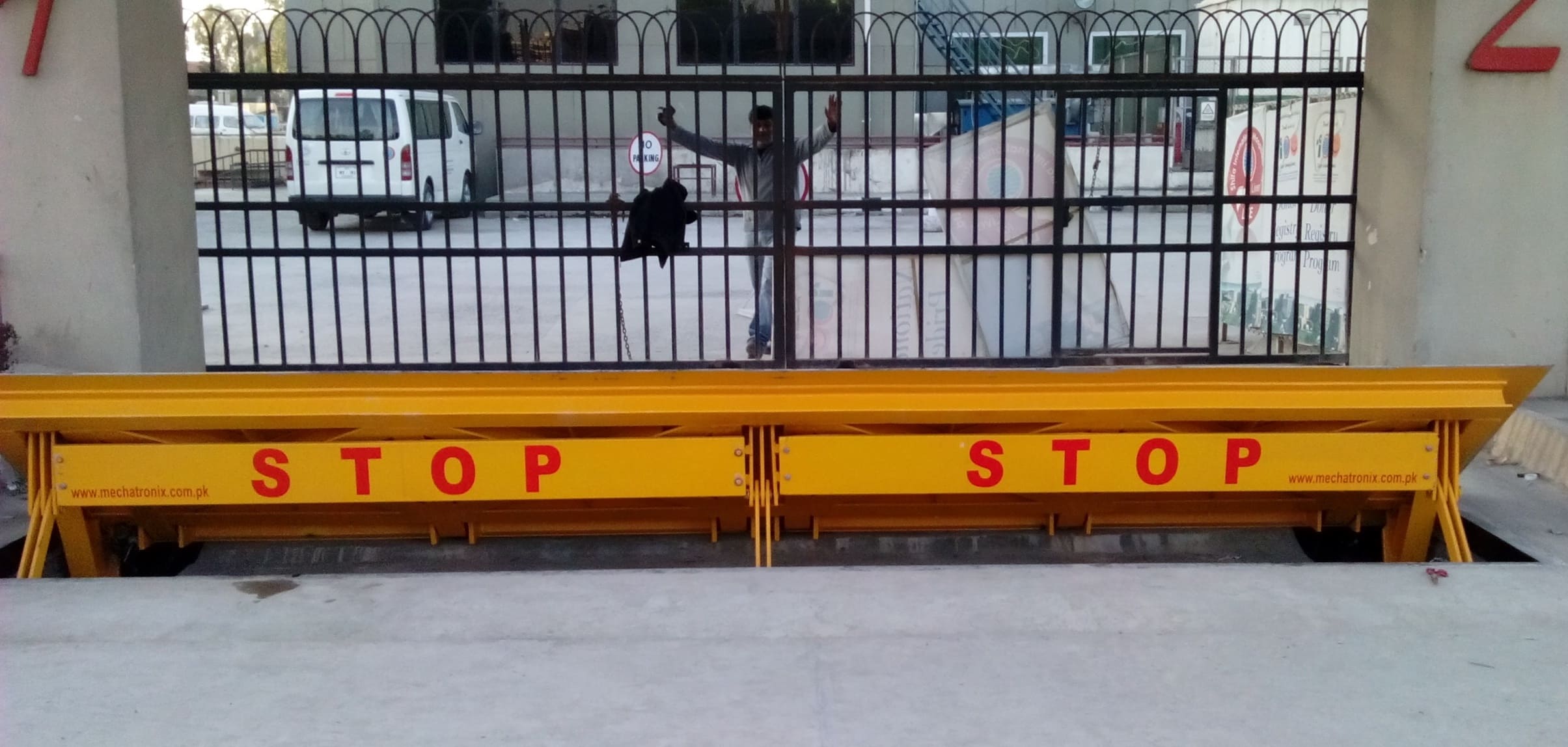 yellow road blocker in open state in front of an entrance gate